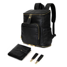 Complete set of black leather nappy backpack with gold zipper, featuring matching black pram clips with gold accents and a black change mat secured with a gold button from Tottie