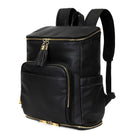 Slight view shot of a black leather nappy backpack with gold hardware from Tottie, displayed against a white background.