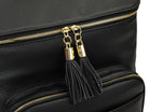 Close-up shot of the black tassel with gold hardware on a black leather nappy backpack with a gold zipper from Tottie