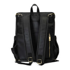 A black leather baby bag backpack with gold zippers on white background