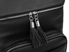 Close-up view of the black tassel with silver hardware on a black leather nappy backpack with a silver zipper from Tottie