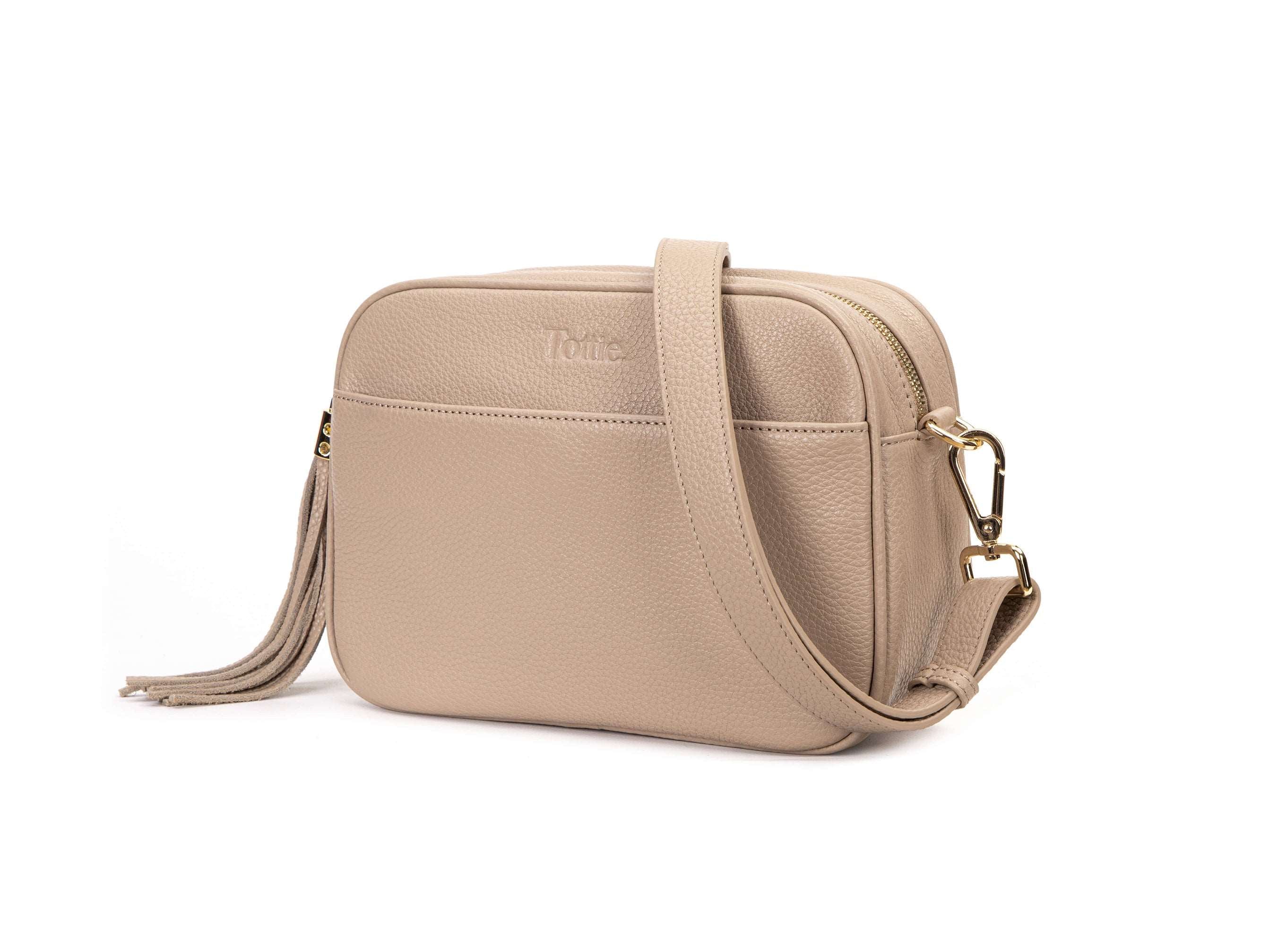 stone colored leather crossbody bag in white background