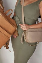 a pregnant woman carrying a bestie crossbody bag