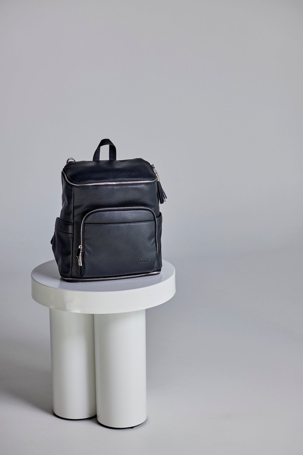 beautiful image of a black leather nappy backpack with a silver zipper from Tottie